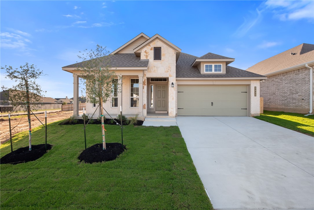 View of front of property with a garage and a fron