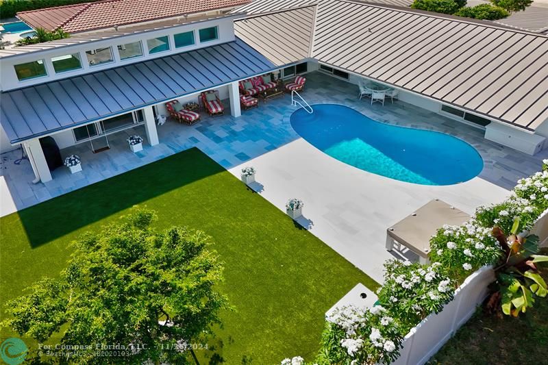 a view of a backyard with sitting area