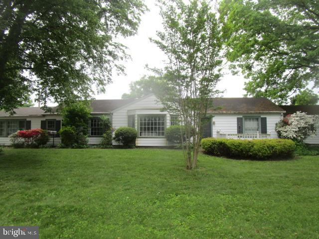 a front view of a house with a garden and yard