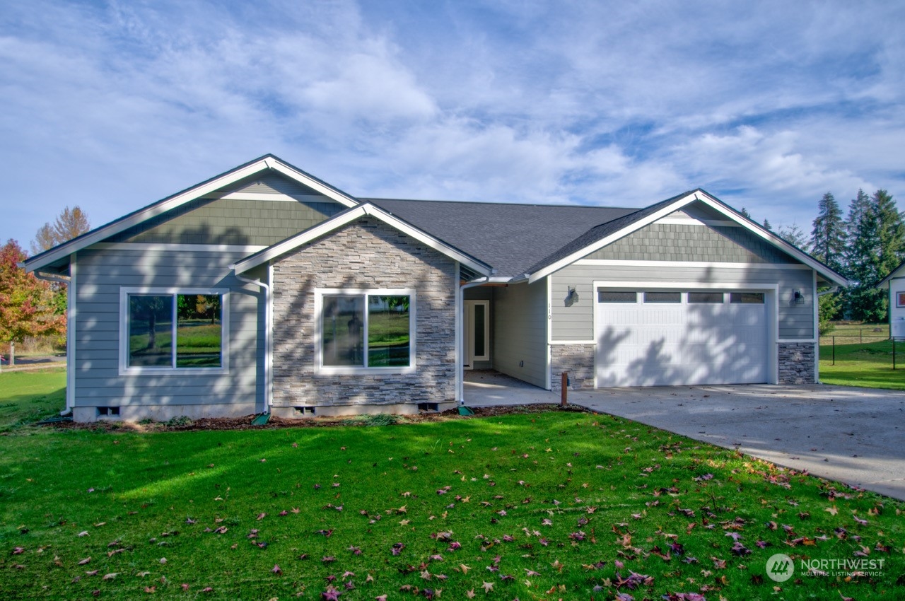 a front view of house with backyard and garden