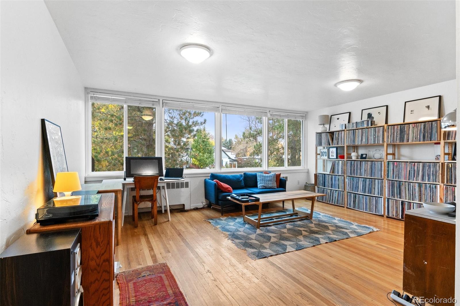 a living room with furniture a rug and a large window