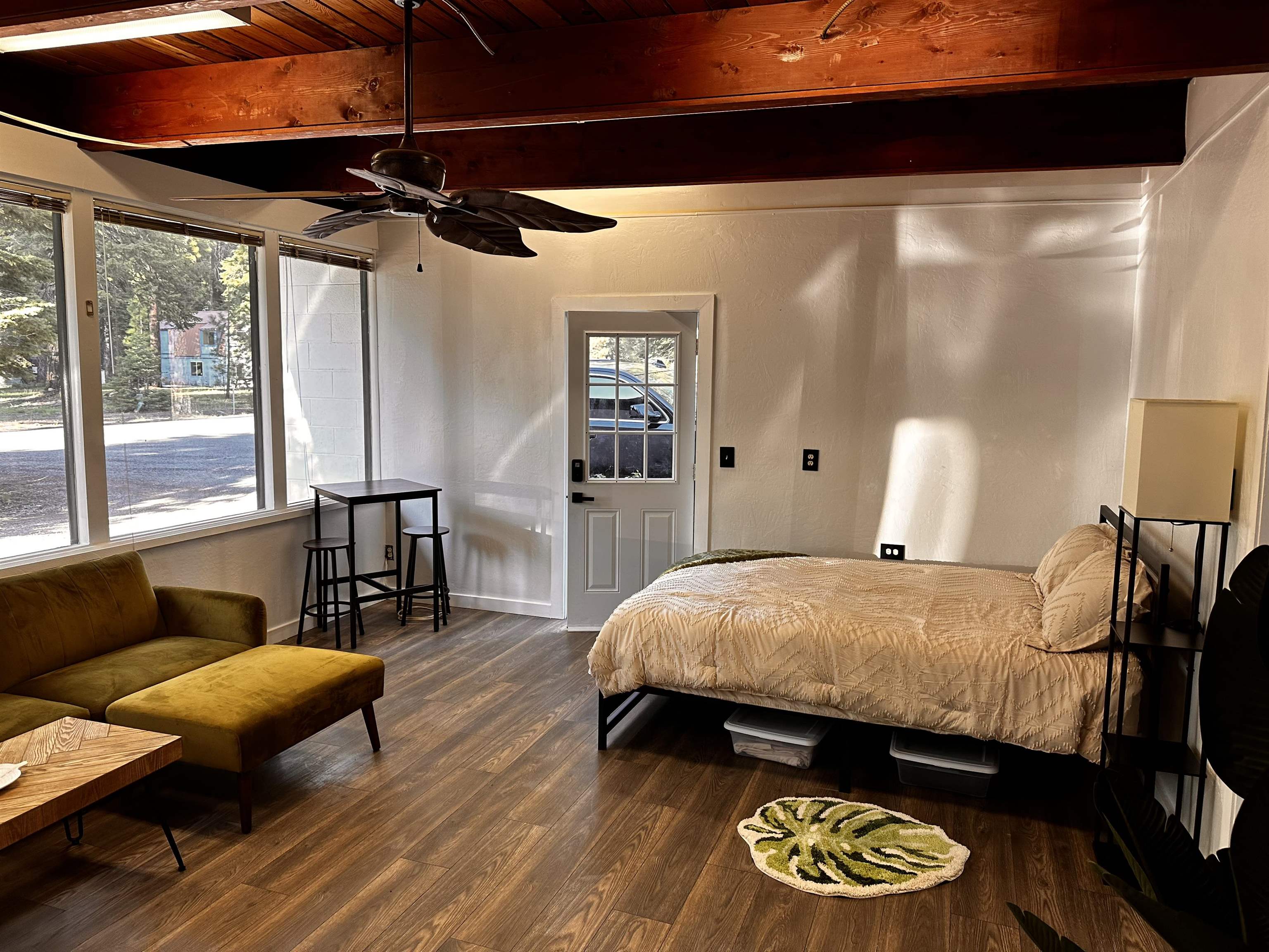 a bedroom with a bed and wooden floor