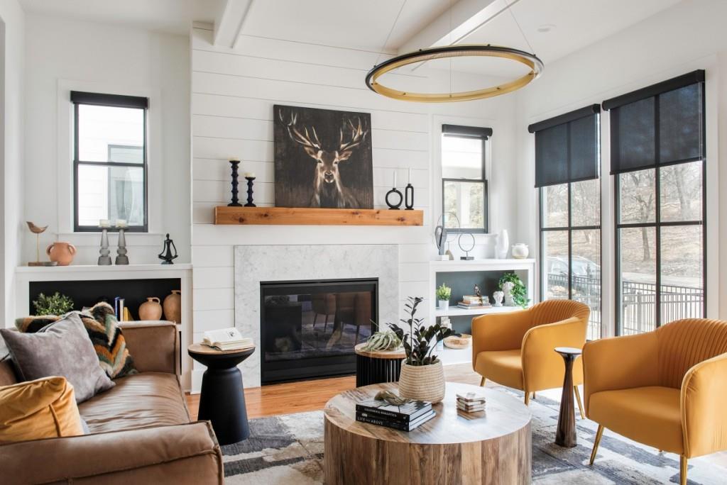 a living room with furniture a fireplace and a large window