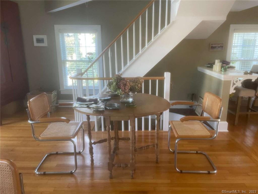 a dining room with furniture a rug and wooden floor