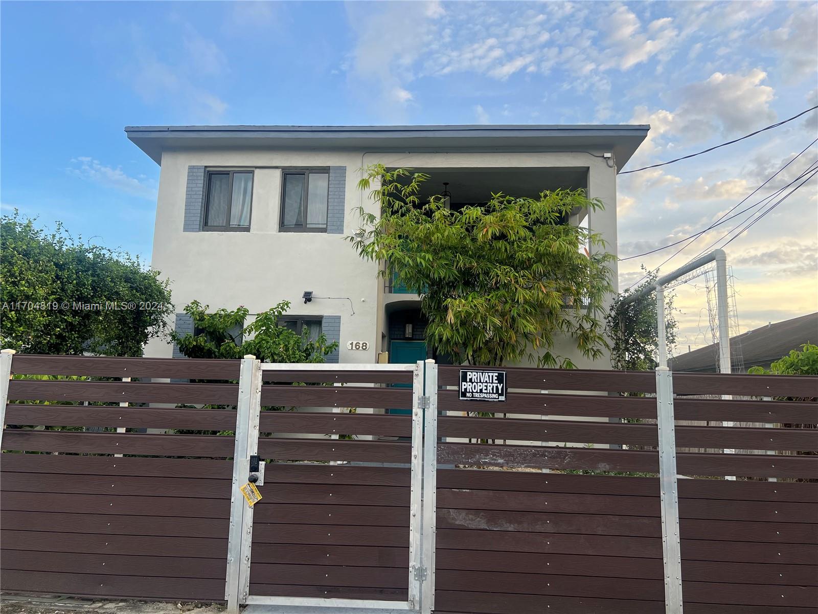 a front view of a house with plants