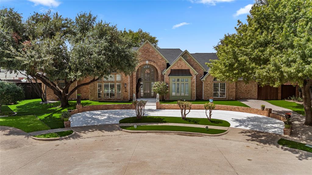 a front view of a house with a yard tree and outdoor seating