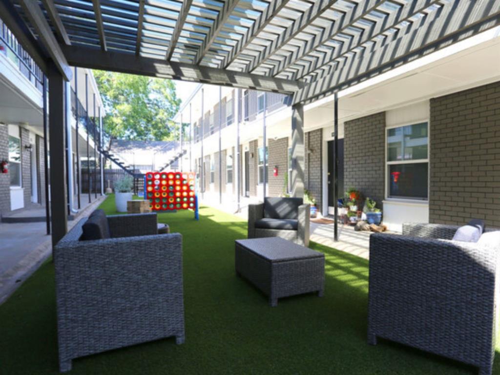 a living room with patio furniture and a potted plants