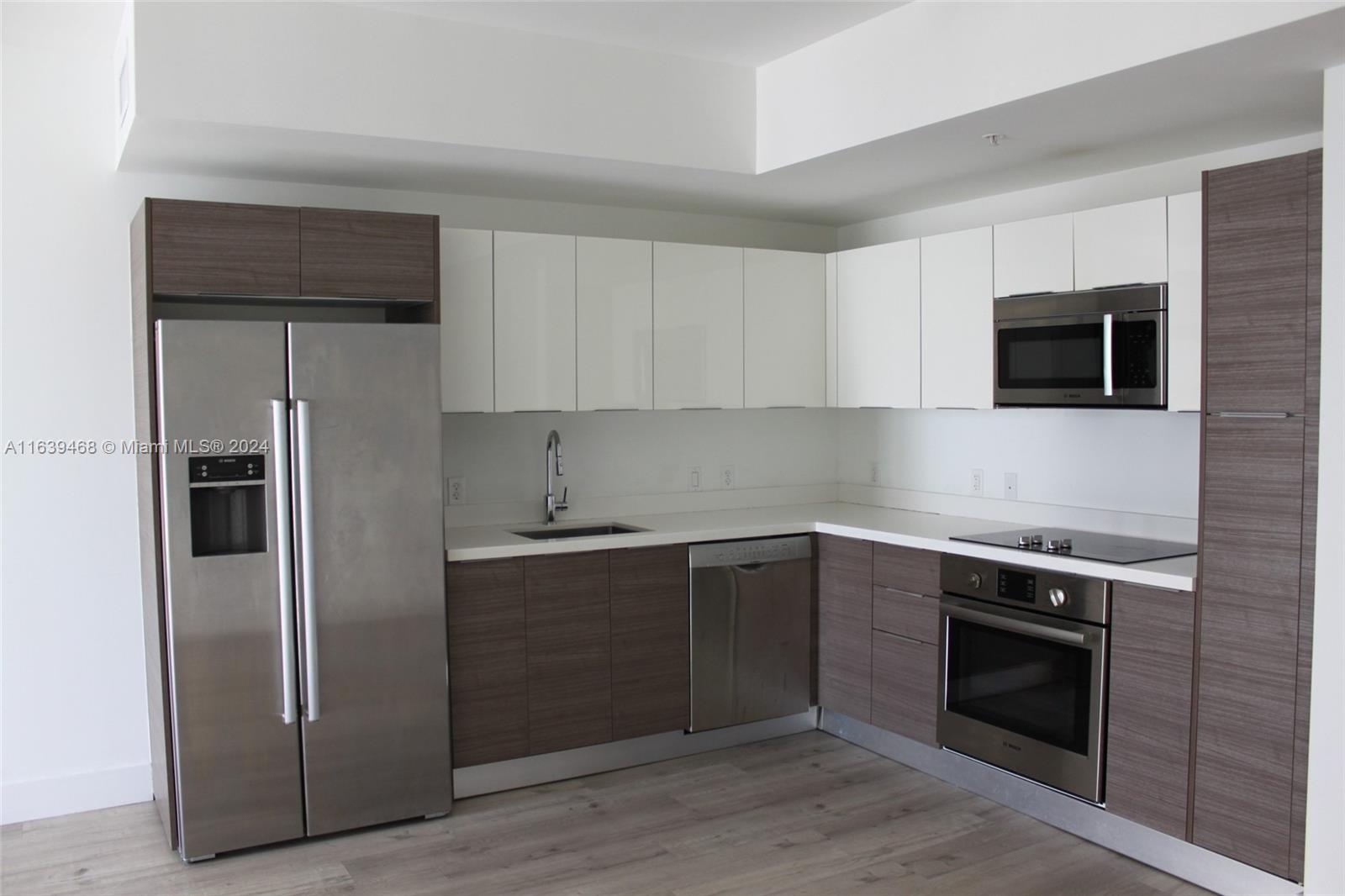 a kitchen with a sink and steel stainless steel appliances