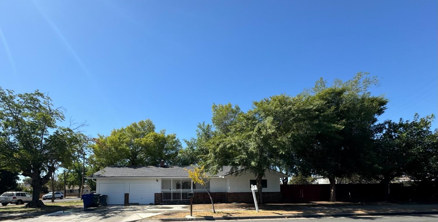 a front view of a building with trees