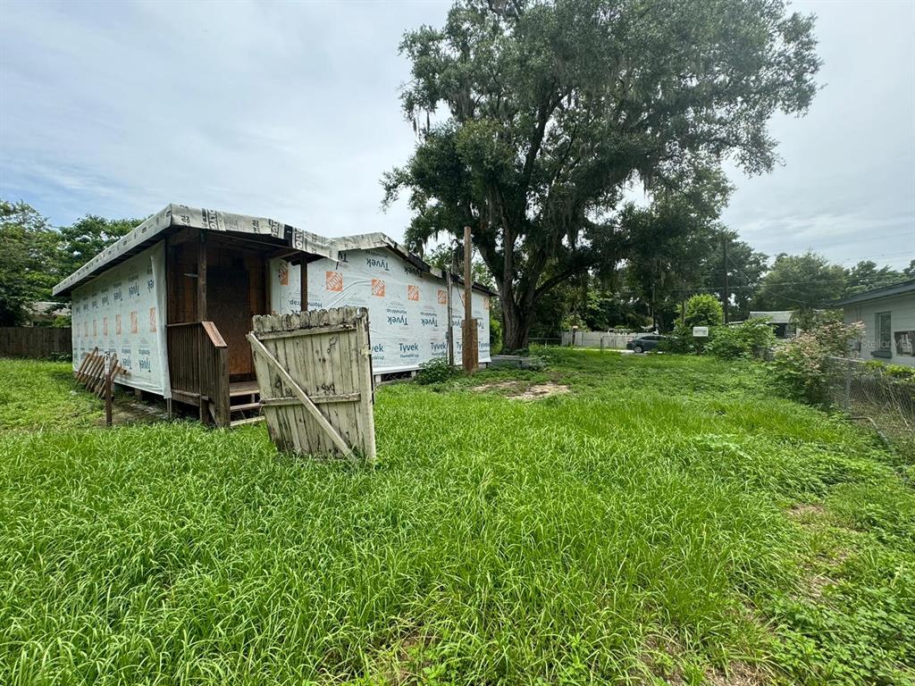 a view of a wooden house with a yard