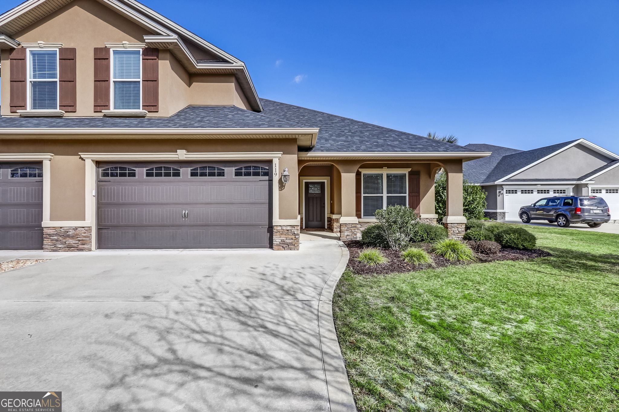 a front view of a house with a yard and garage