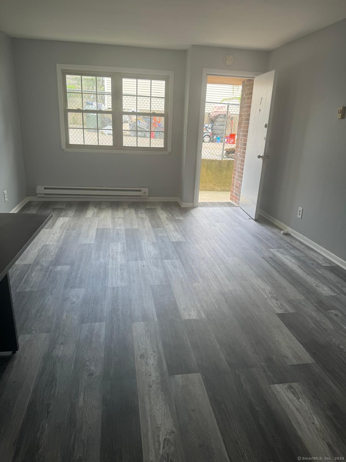 wooden floor in an empty room with a window