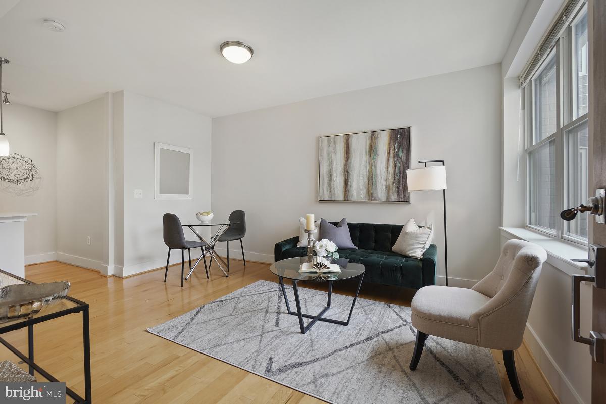 a living room with furniture a fireplace and a table