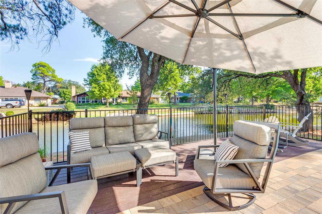 a view of a patio with couches and pool