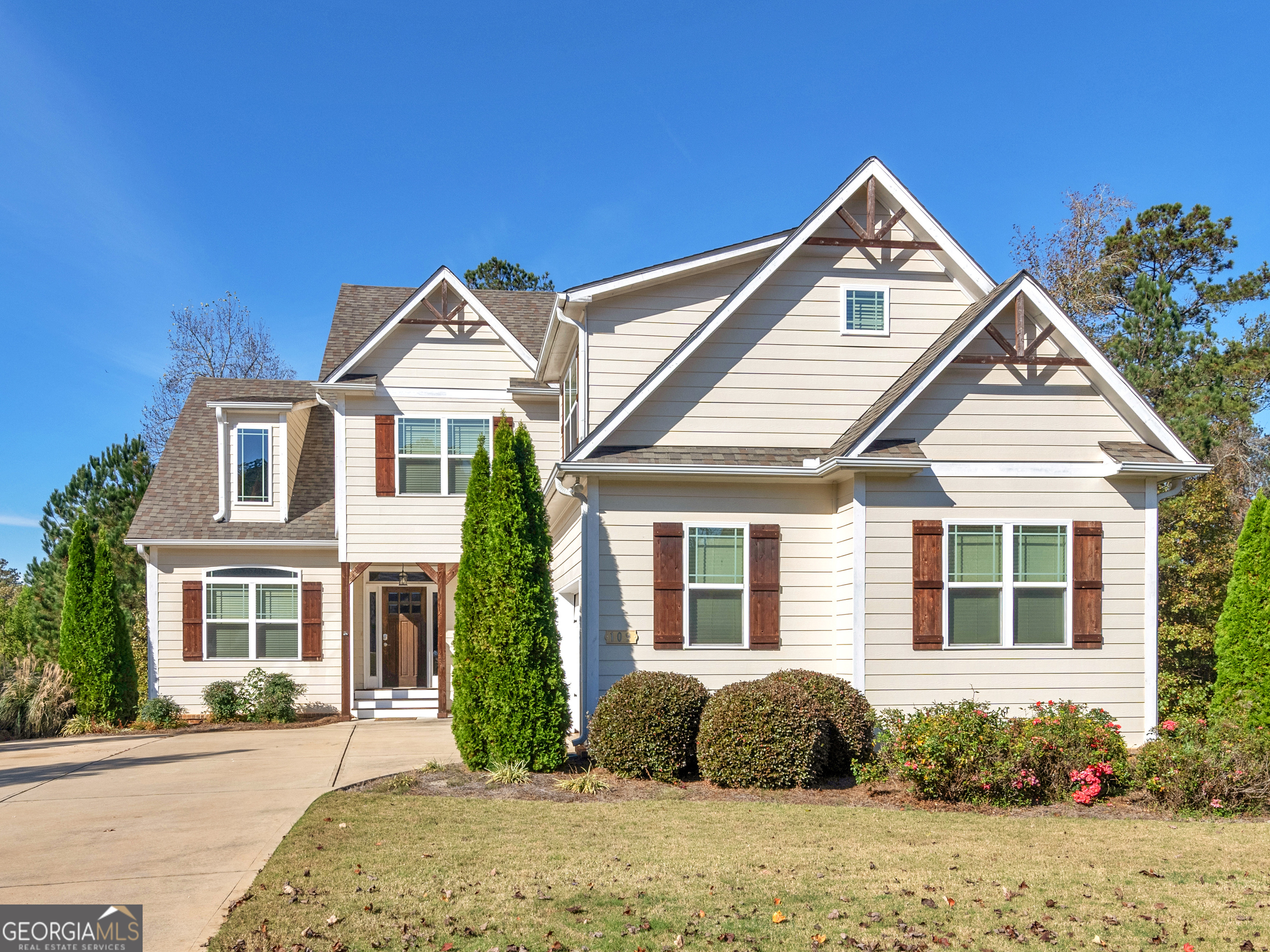 a front view of a house with a garden