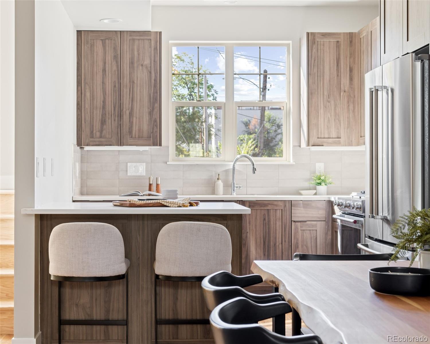 a kitchen with a table chairs sink stove and refrigerator