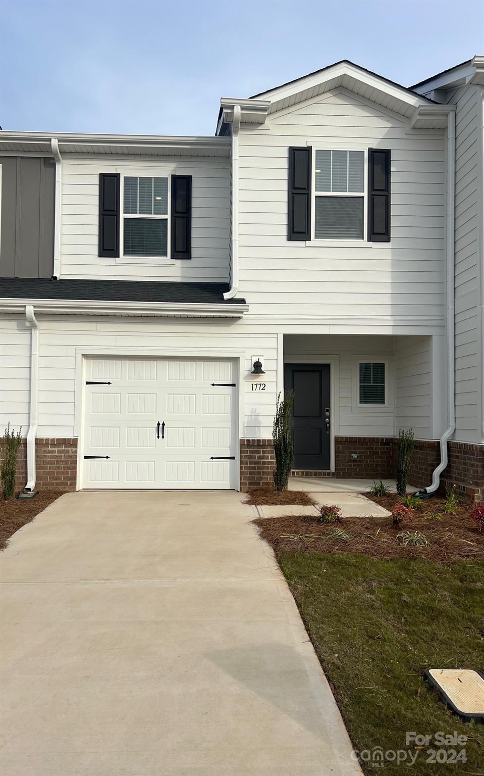 a front view of a house with parking space