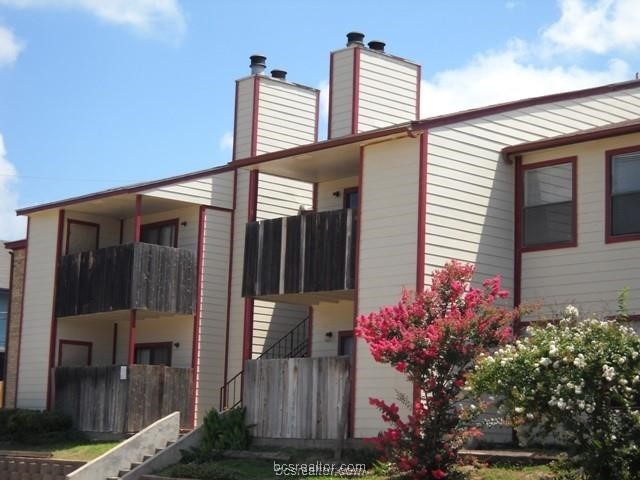 a front view of a house with plants