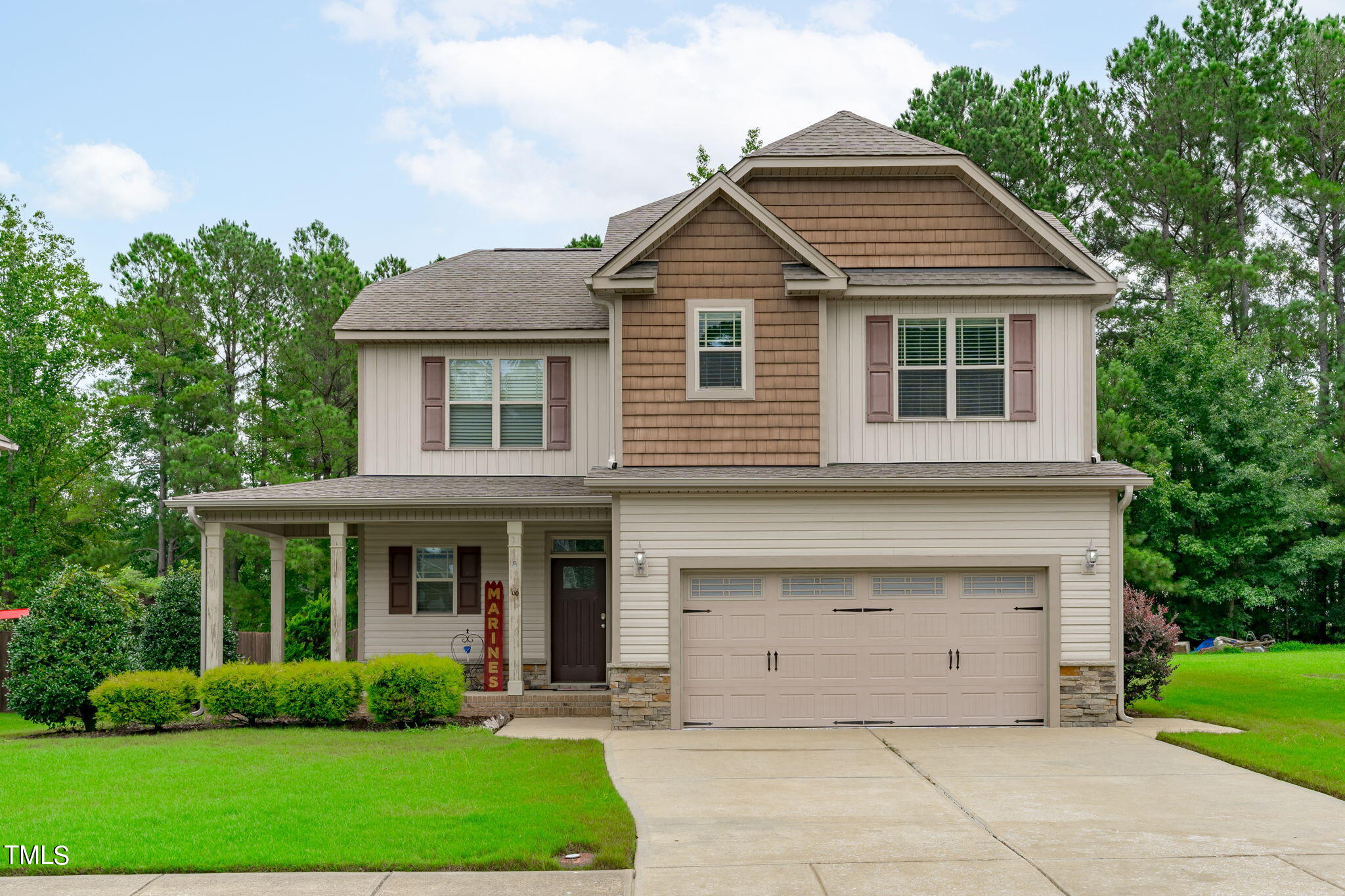 a front view of a house with a garden