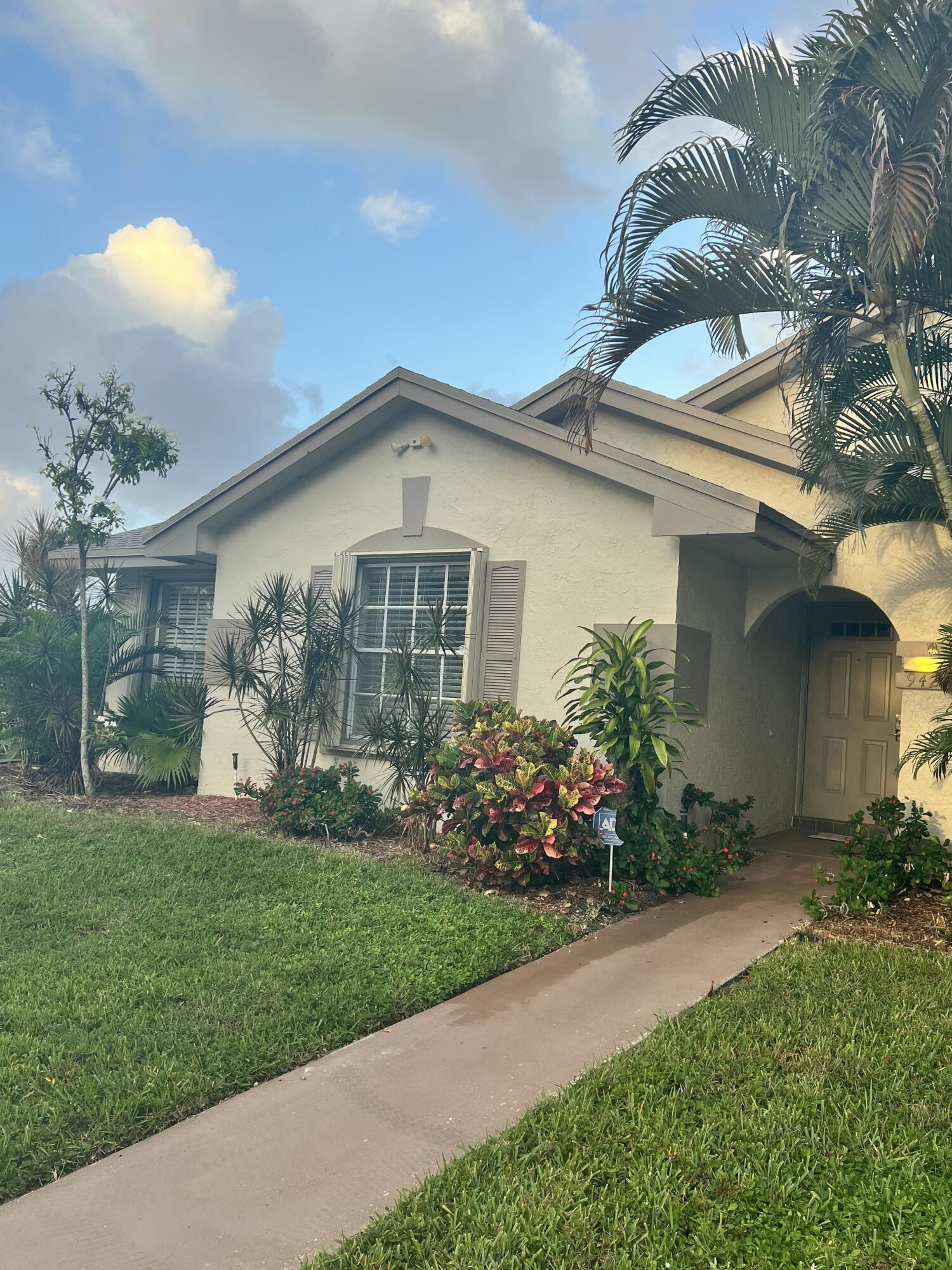 a front view of a house with a garden