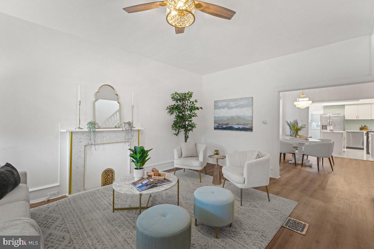 a living room with furniture a rug and a chandelier