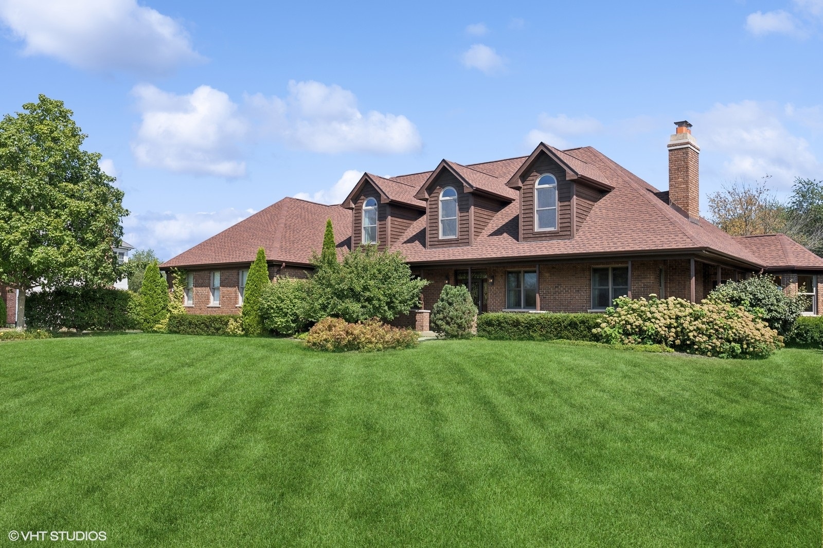 a front view of a house with a garden