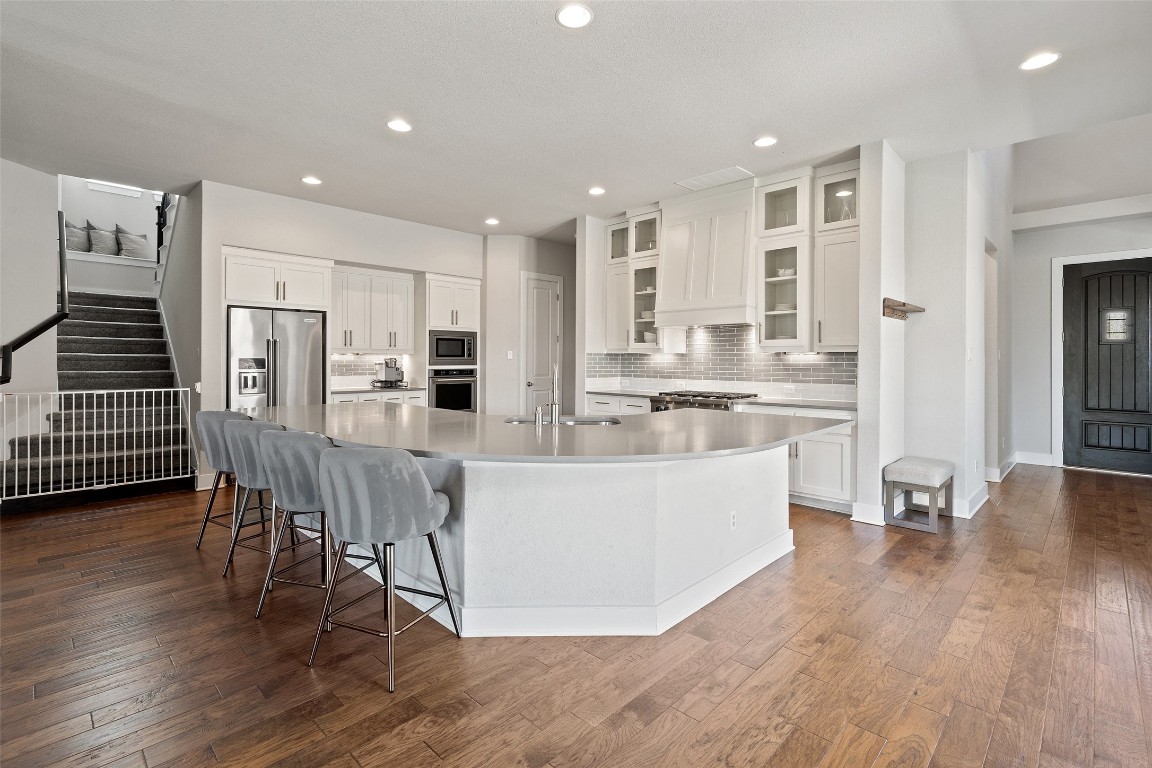 a large kitchen with a table and chairs