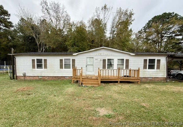 a view of a house with a yard and sitting area