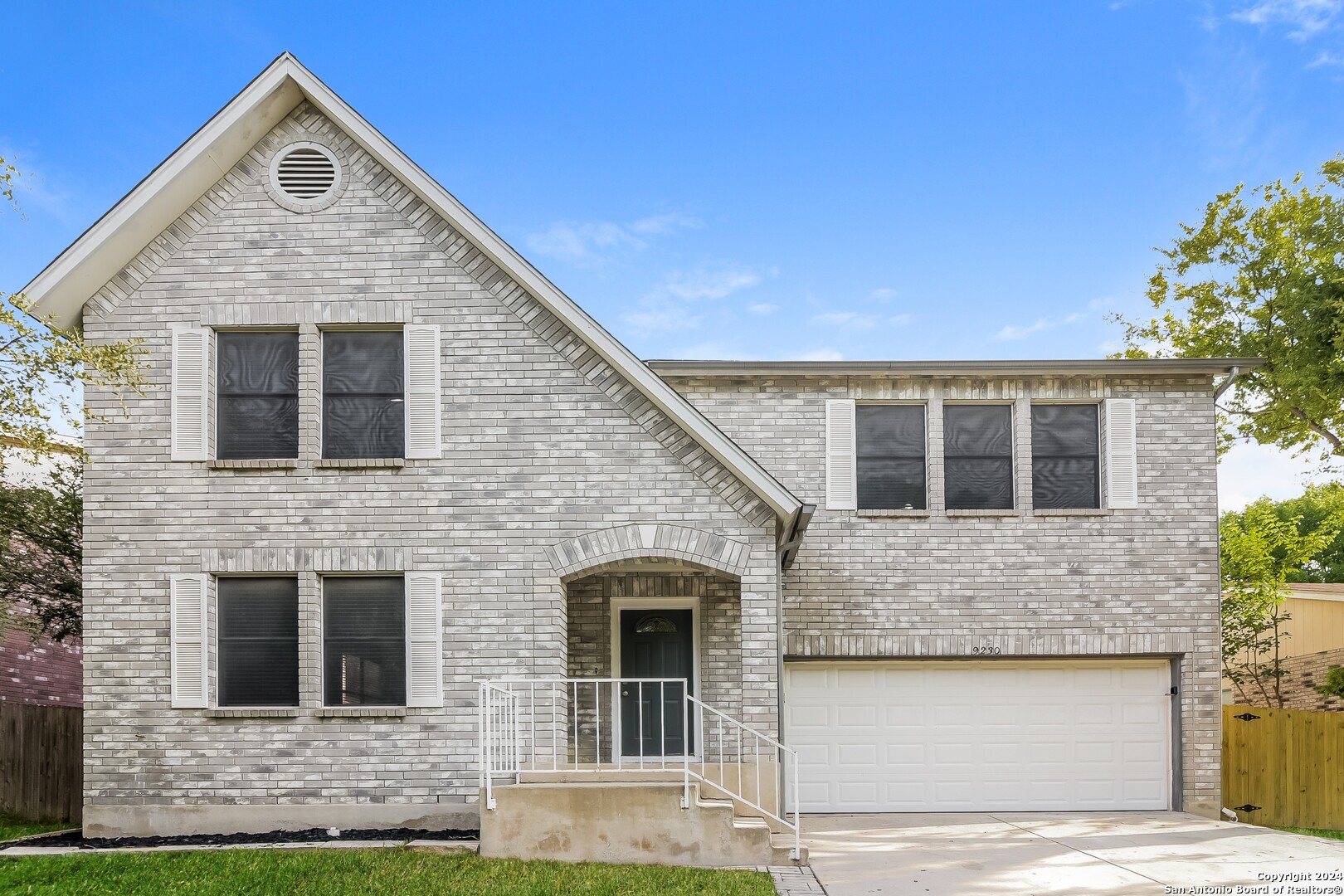 a front view of a house with garage