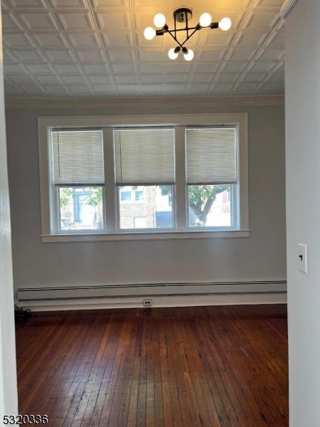 a view of a room with wooden floors and a window