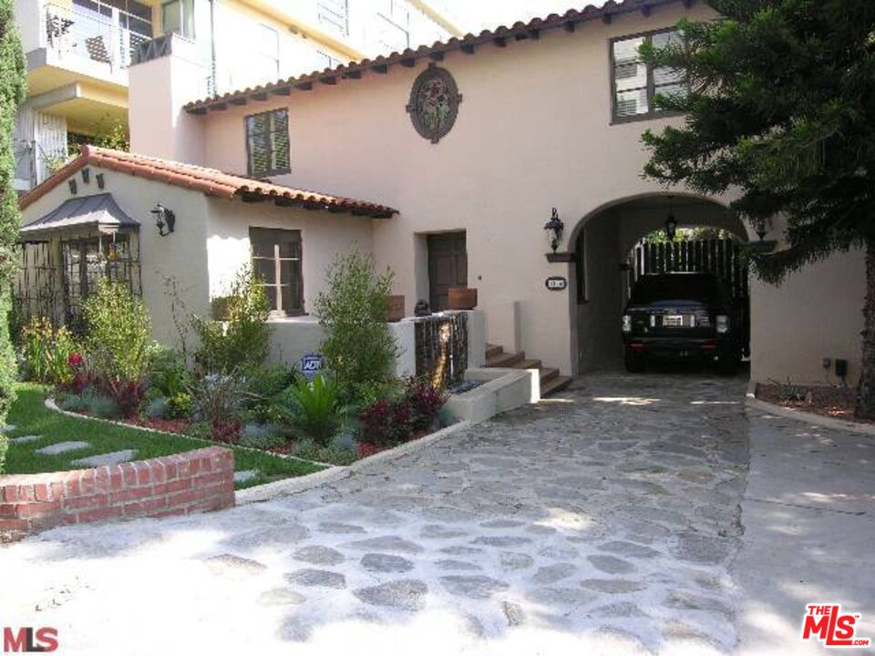 a view of a car parked in front of a house