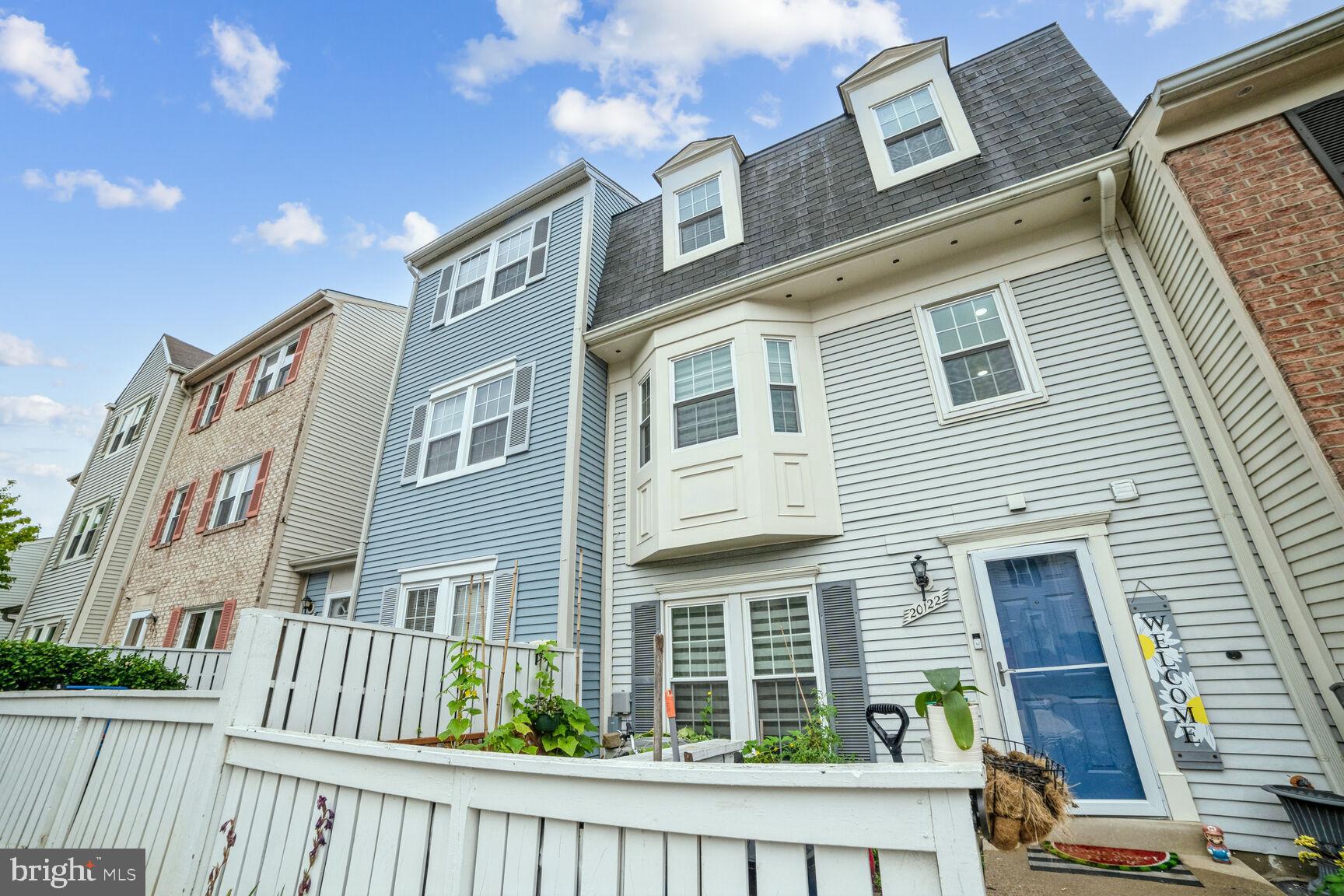 a front view of a residential apartment building with a yard