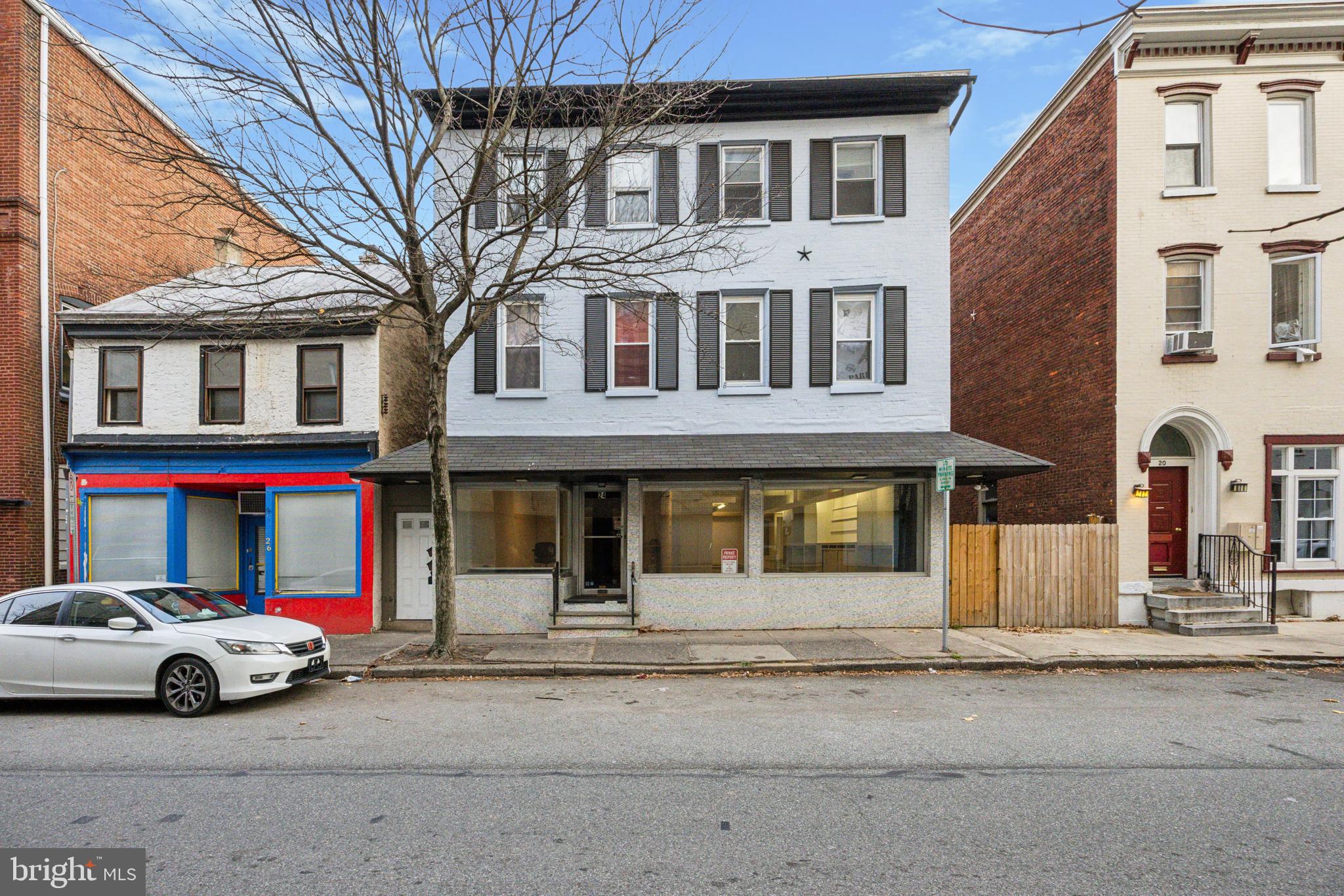 a front view of a residential apartment building with a yard