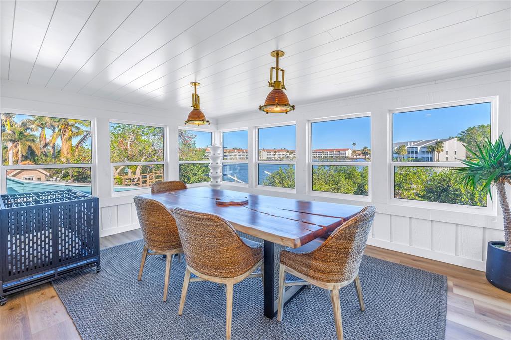 a view of a dining room with furniture a chandelier and wooden floor