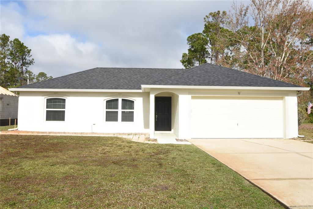 a front view of a house with a big yard