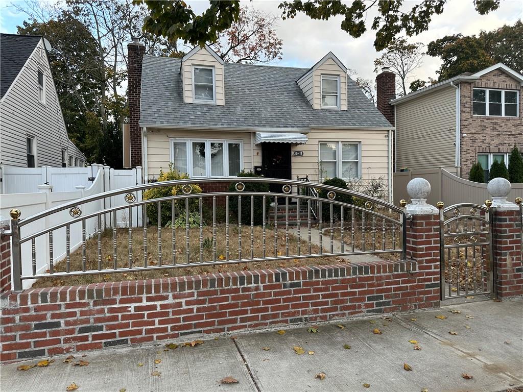 a view of a house with wooden fence