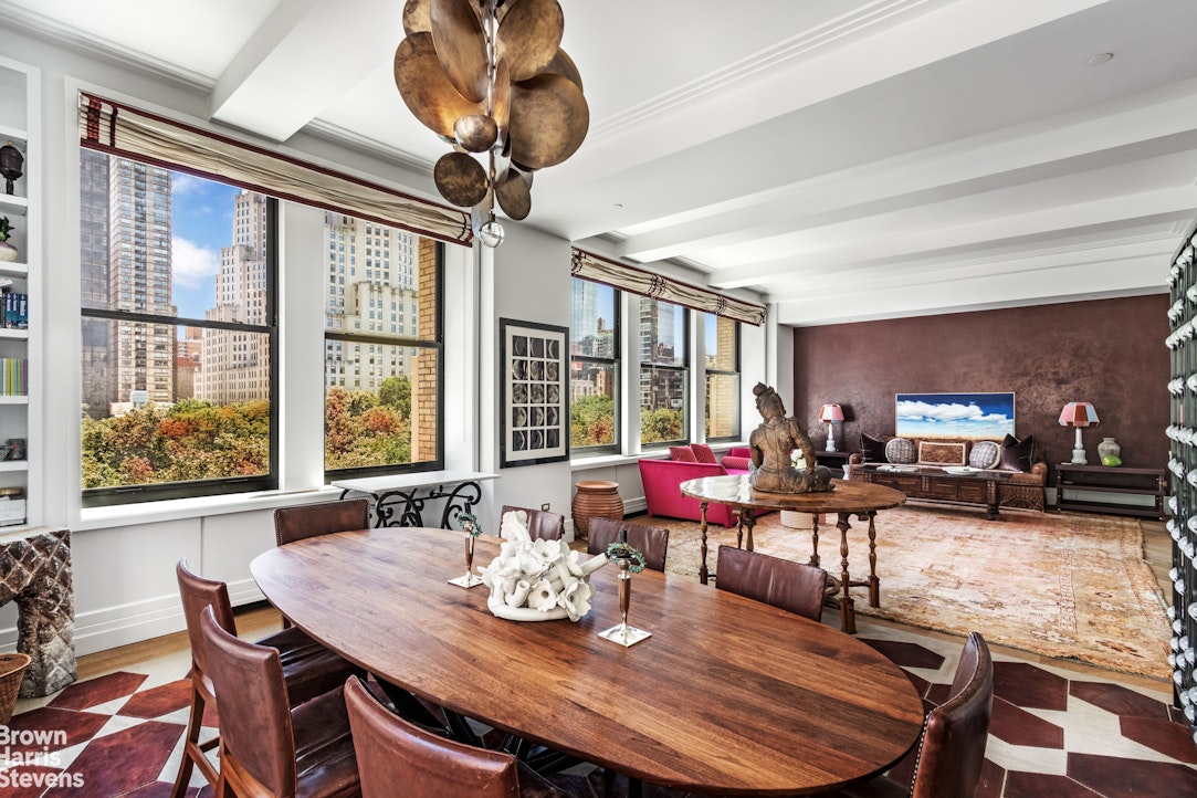 a view of a dining room with furniture large windows and wooden floor