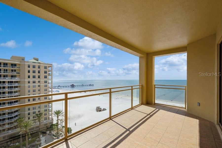 a view of balcony with floor to ceiling windows and city view