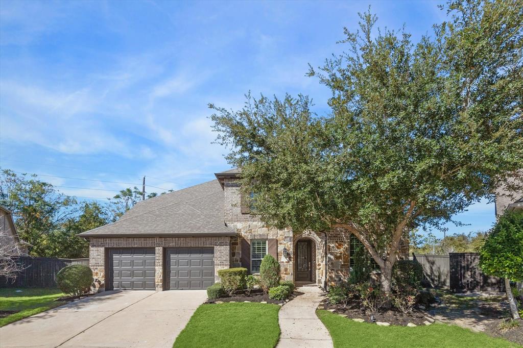 STUNNING BRICK AND STONE ELEVATION HOME OFFERS 3-CAR TANDEM GARAGE.