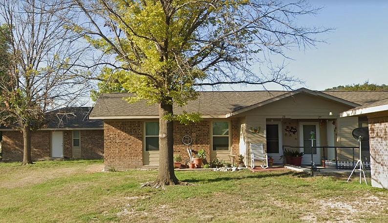 a front view of a house with a yard garage and outdoor seating