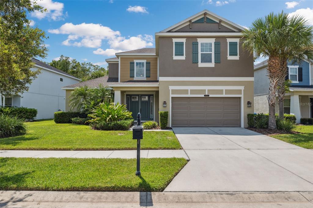 a front view of a house with a yard and garage