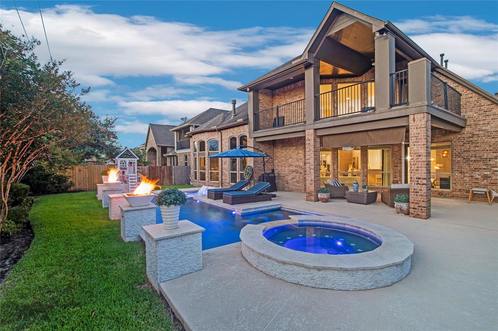 a view of a house with swimming pool and sitting area