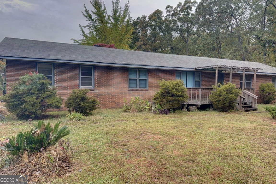 a house that has a lot of plants and trees in front of it