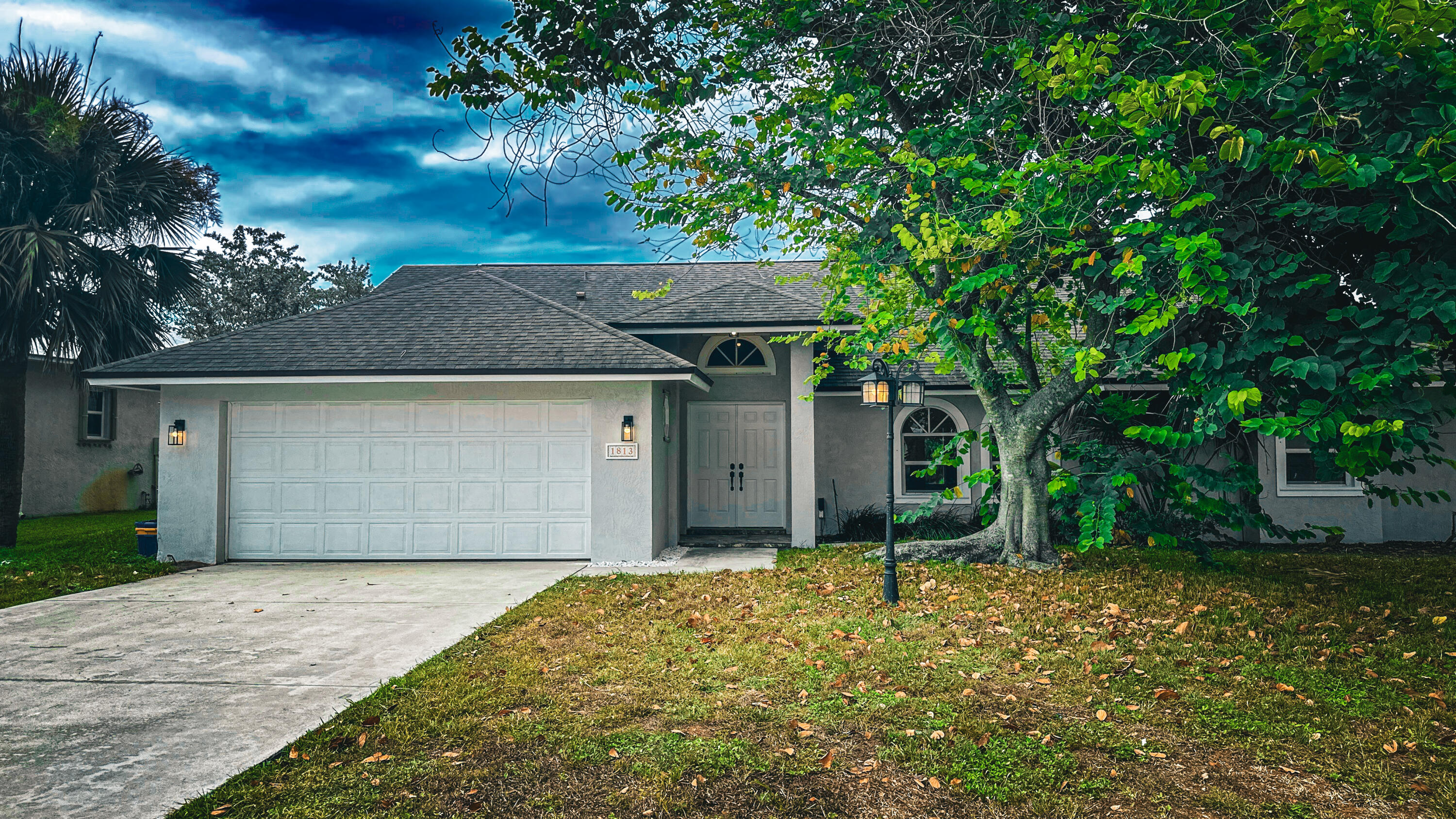 a front view of a house with a garden