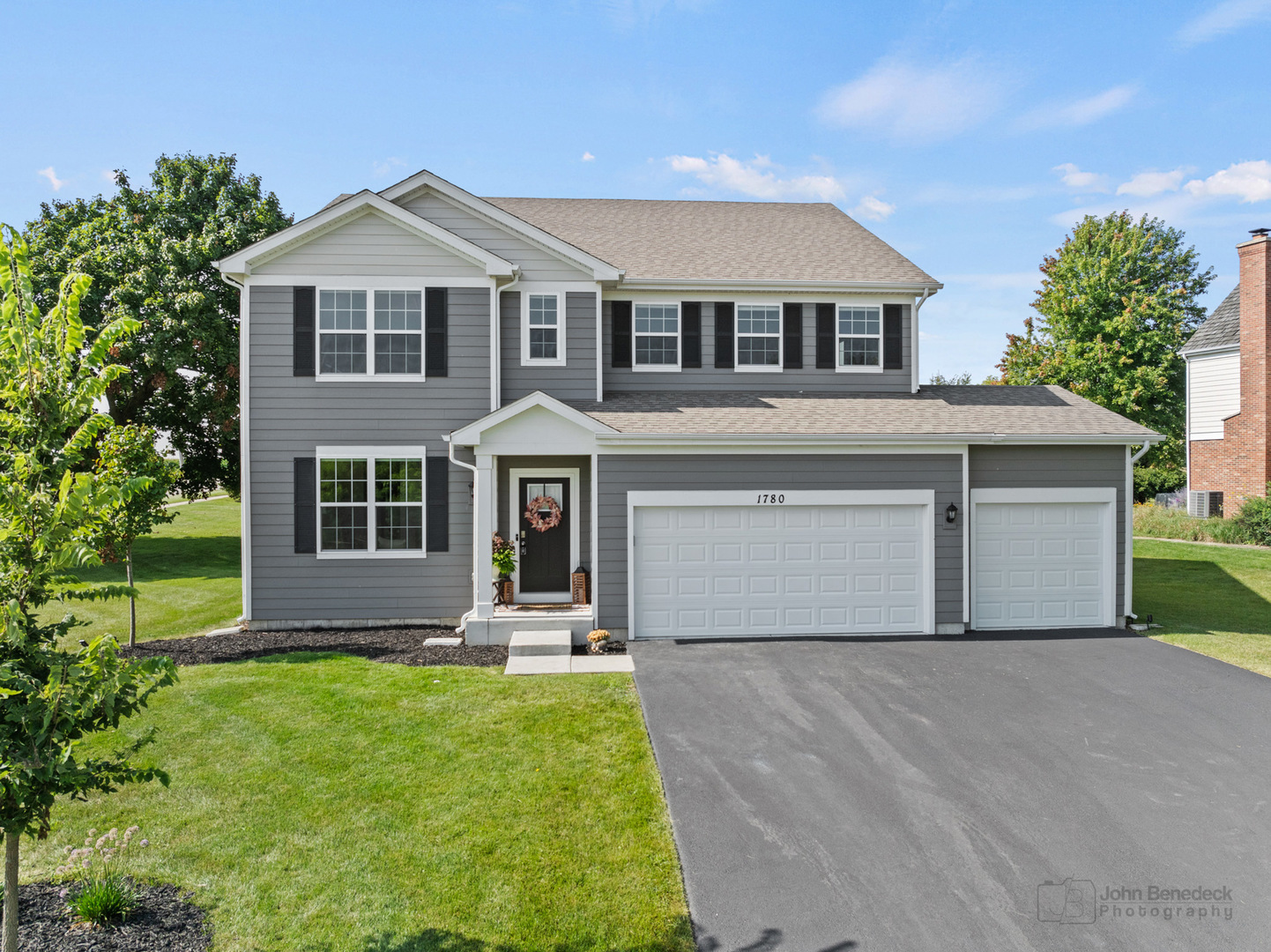 a front view of a house with a yard and garage