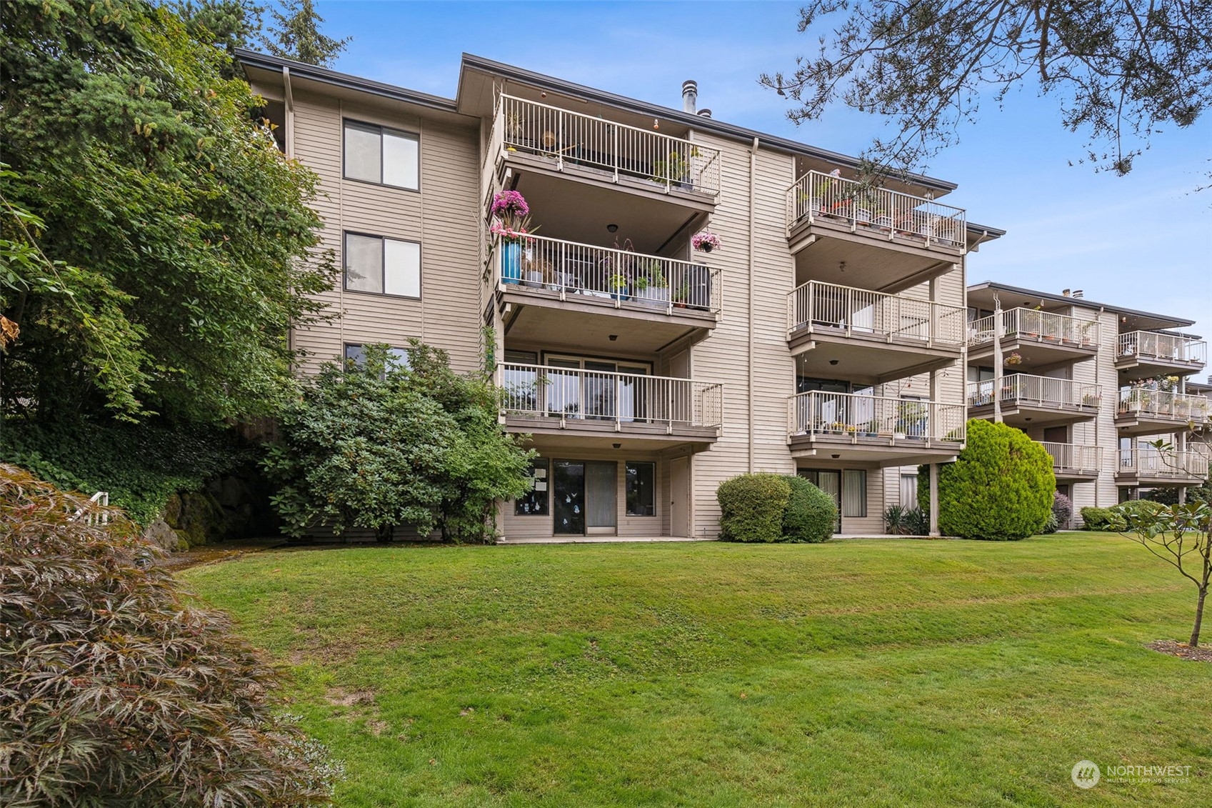 a front view of a residential apartment building with a yard