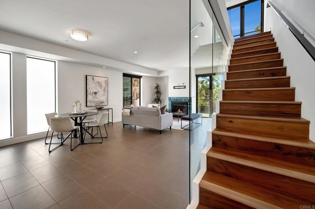 a living room with furniture and stairs