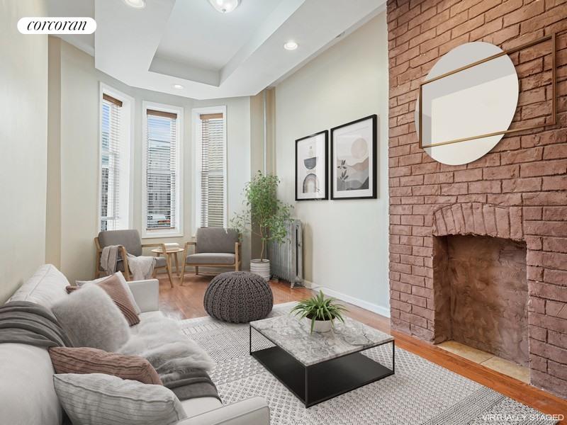 a living room with furniture potted plant and a fireplace