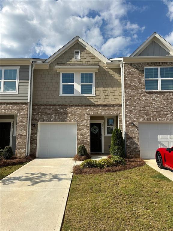 a view of a house with a yard in front of it