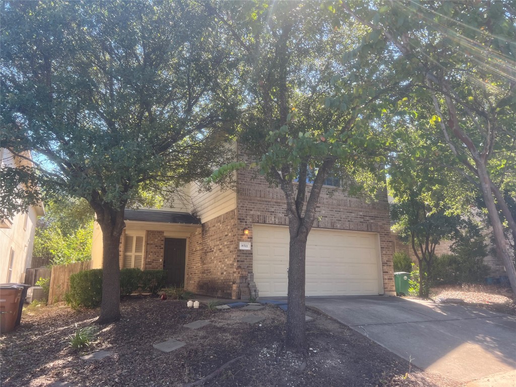 a view of a house with a tree and a yard